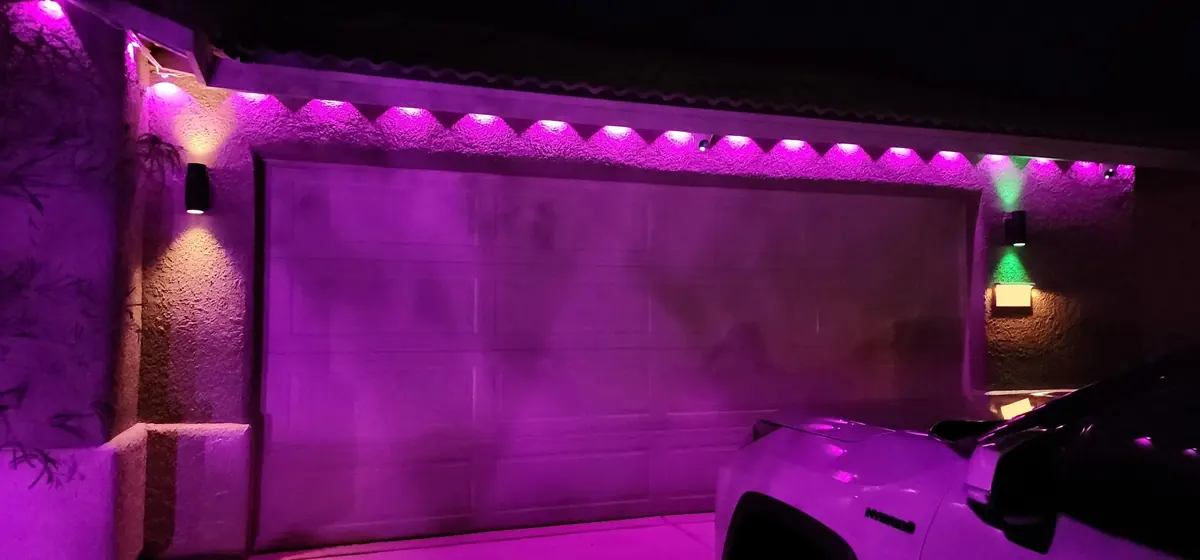 Permanent LED Christmas lights installed along the eaves of a home