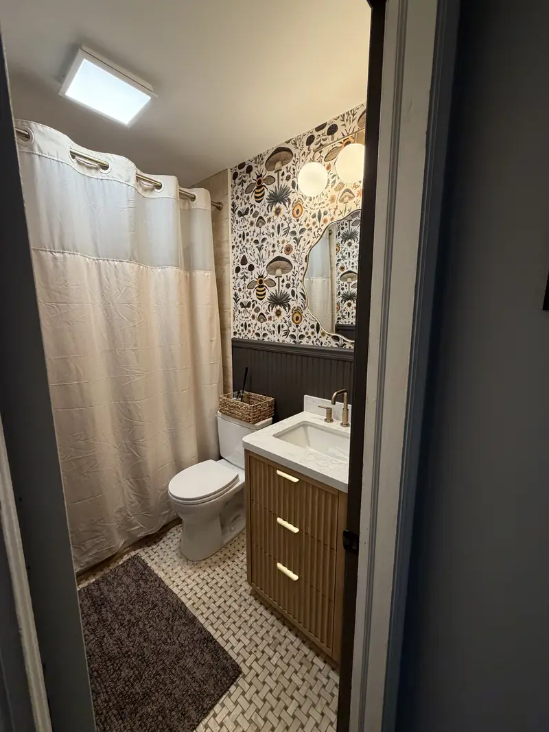 Bathroom remodel with floral wallpaper and marble vanity by Tampa Handyman in Tampa FL